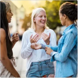 Three colleagues talking outdoors