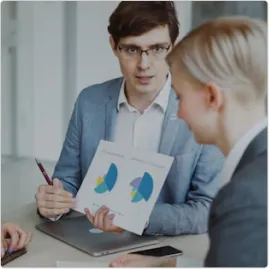 Colleagues reviewing printed charts in a meeting