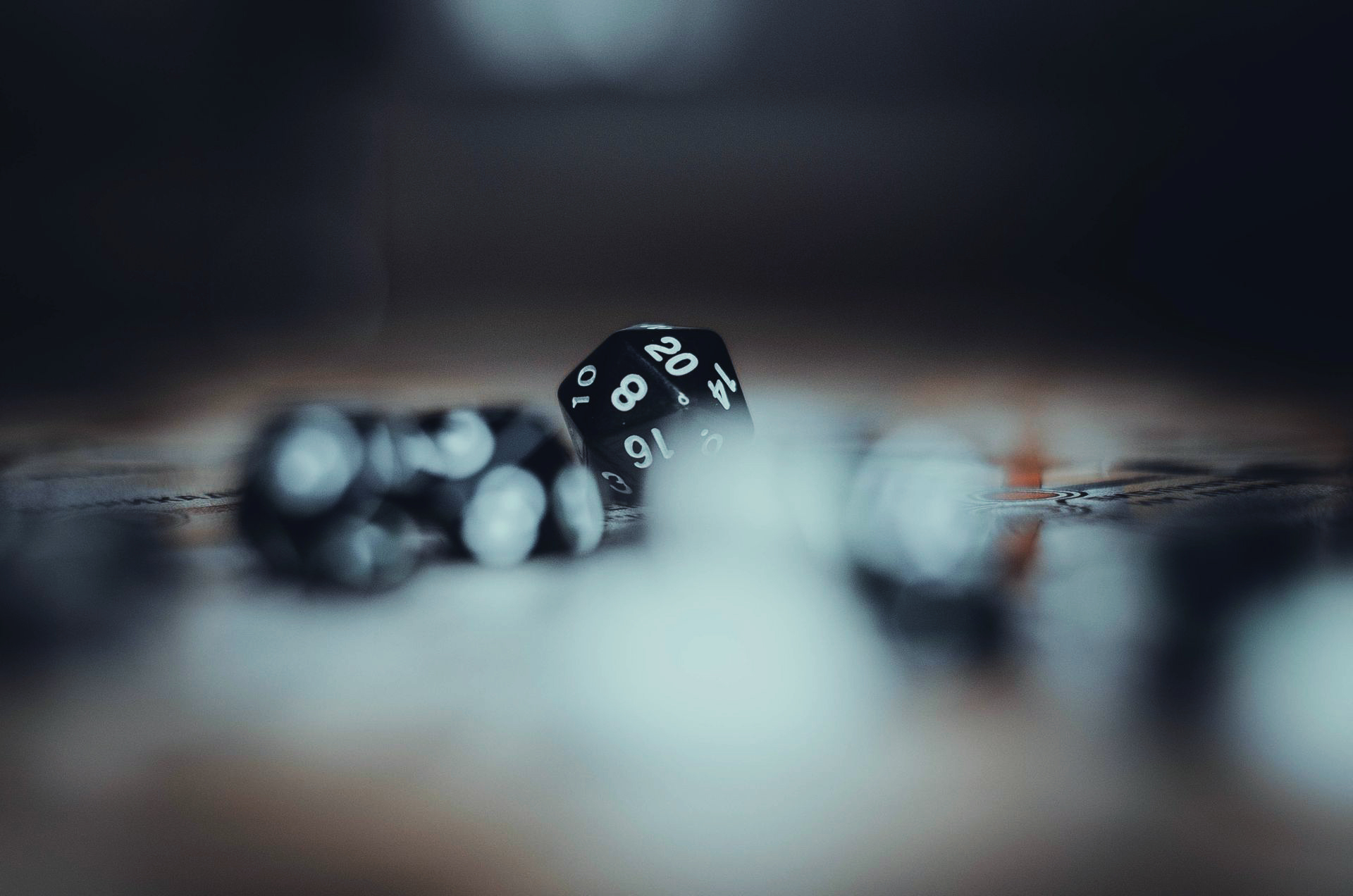 Black polyhedral dice on a table